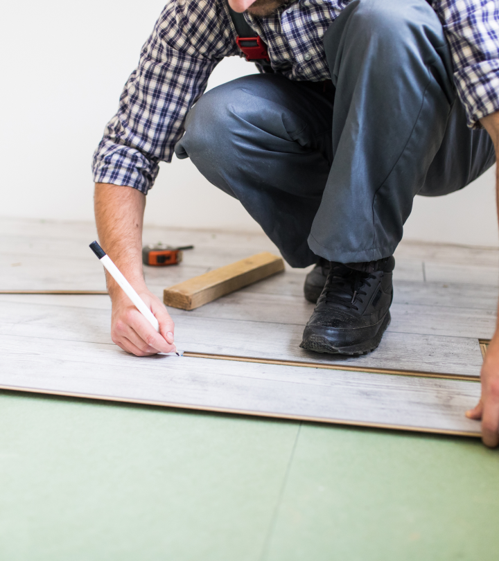 Worker installing laminated flooring boards professionally